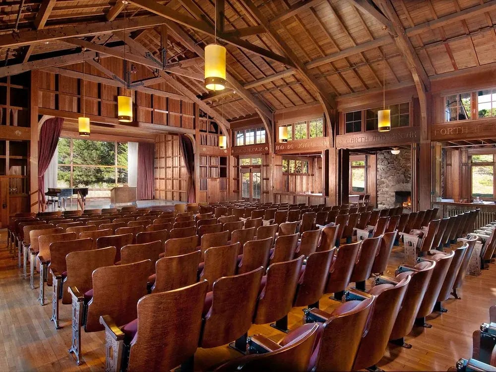 rustic-wooden-auditorium-with-rows-of-brown-seats-facing-asilomar-hotel-and-conference-grounds-paci...