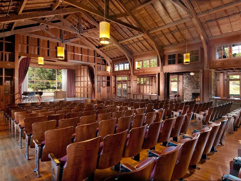 rustic-wooden-auditorium-with-rows-of-brown-seats-facing-asilomar-hotel-and-conference-grounds-paci...